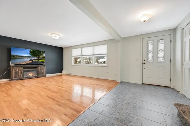 a view of empty room with a fireplace