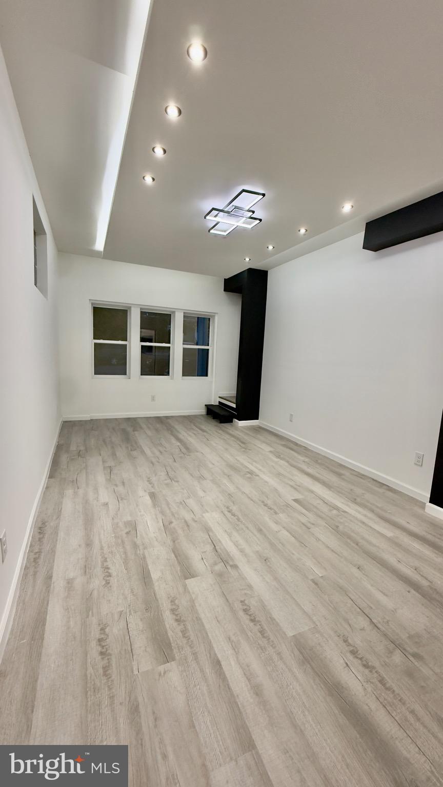 2319 Fairview Avenue Reading, PA 19606 - Photo 20 of 58 a view of an empty room with wooden floor and windows