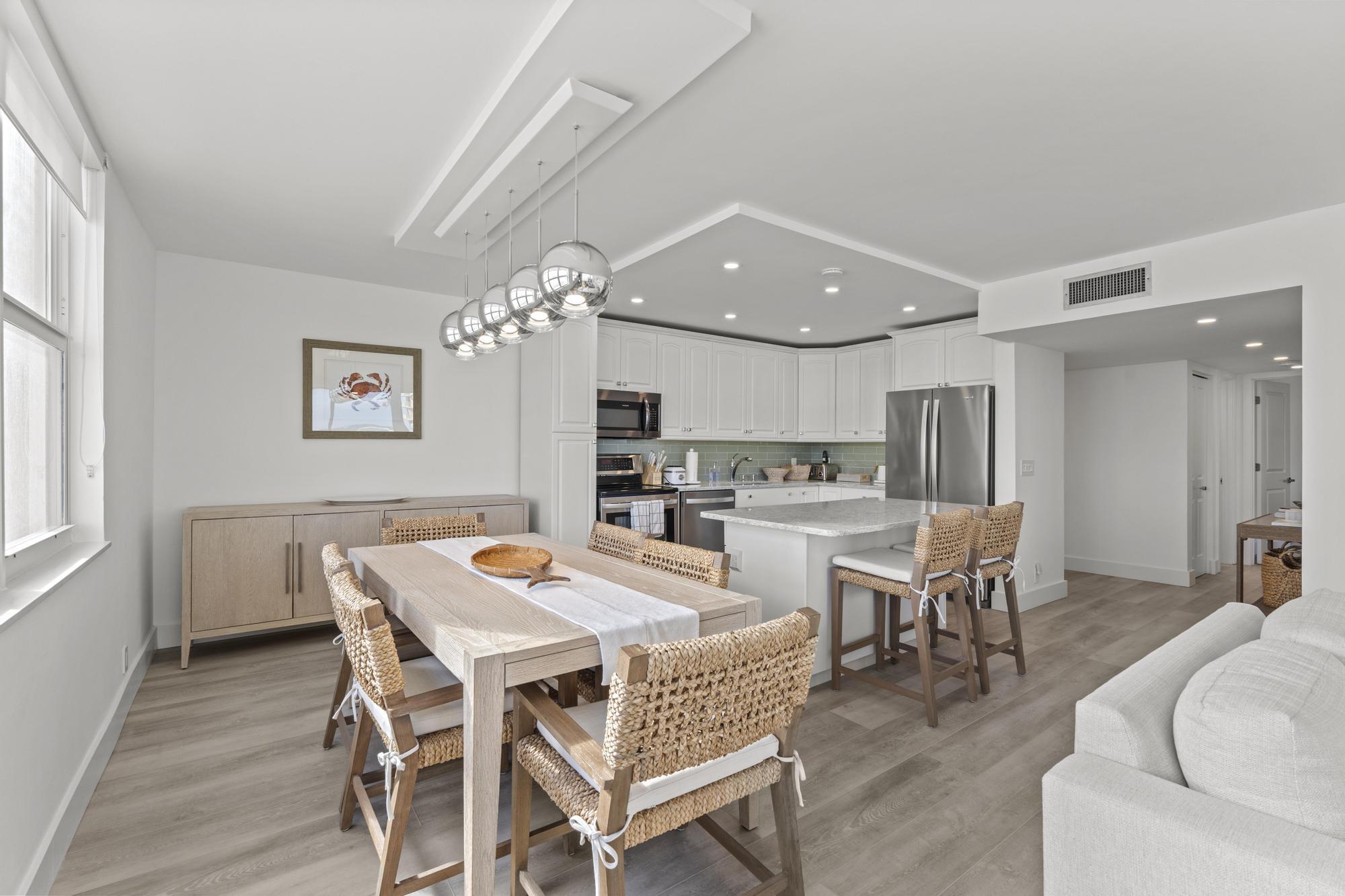 5440 North Ocean Drive, Unit 306 Singer Island, FL 33404 - Photo 11 of 43 a view of a dining room with furniture and wooden floor