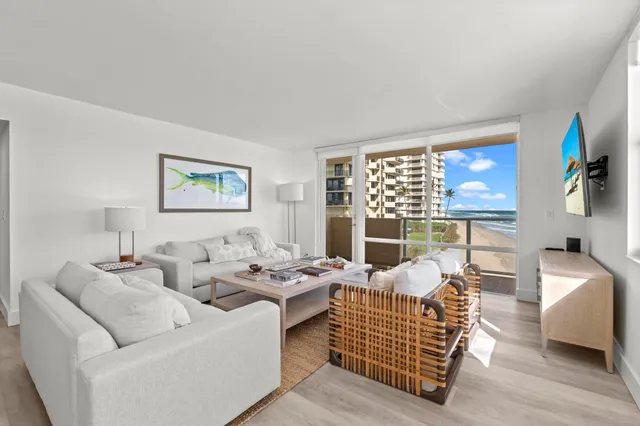 a living room with furniture fireplace and a large window