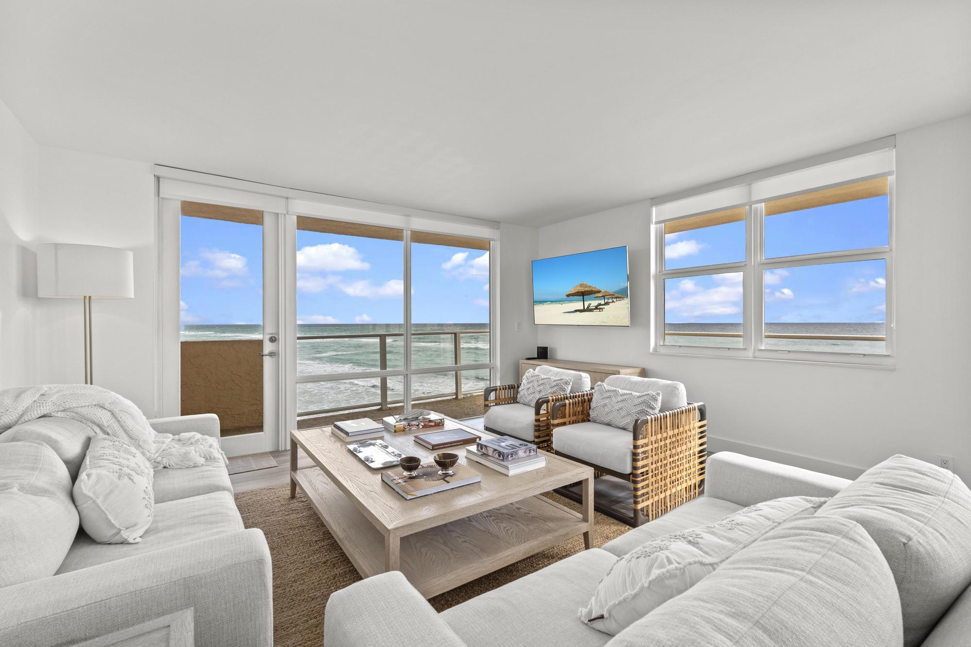 5440 North Ocean Drive, Unit 306 Singer Island, FL 33404 - Photo 22 of 43 a living room with furniture a large window and a table