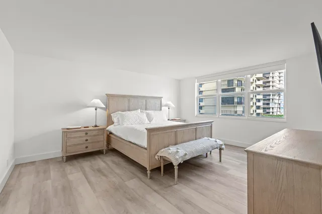 a bed room with a bed and a chair