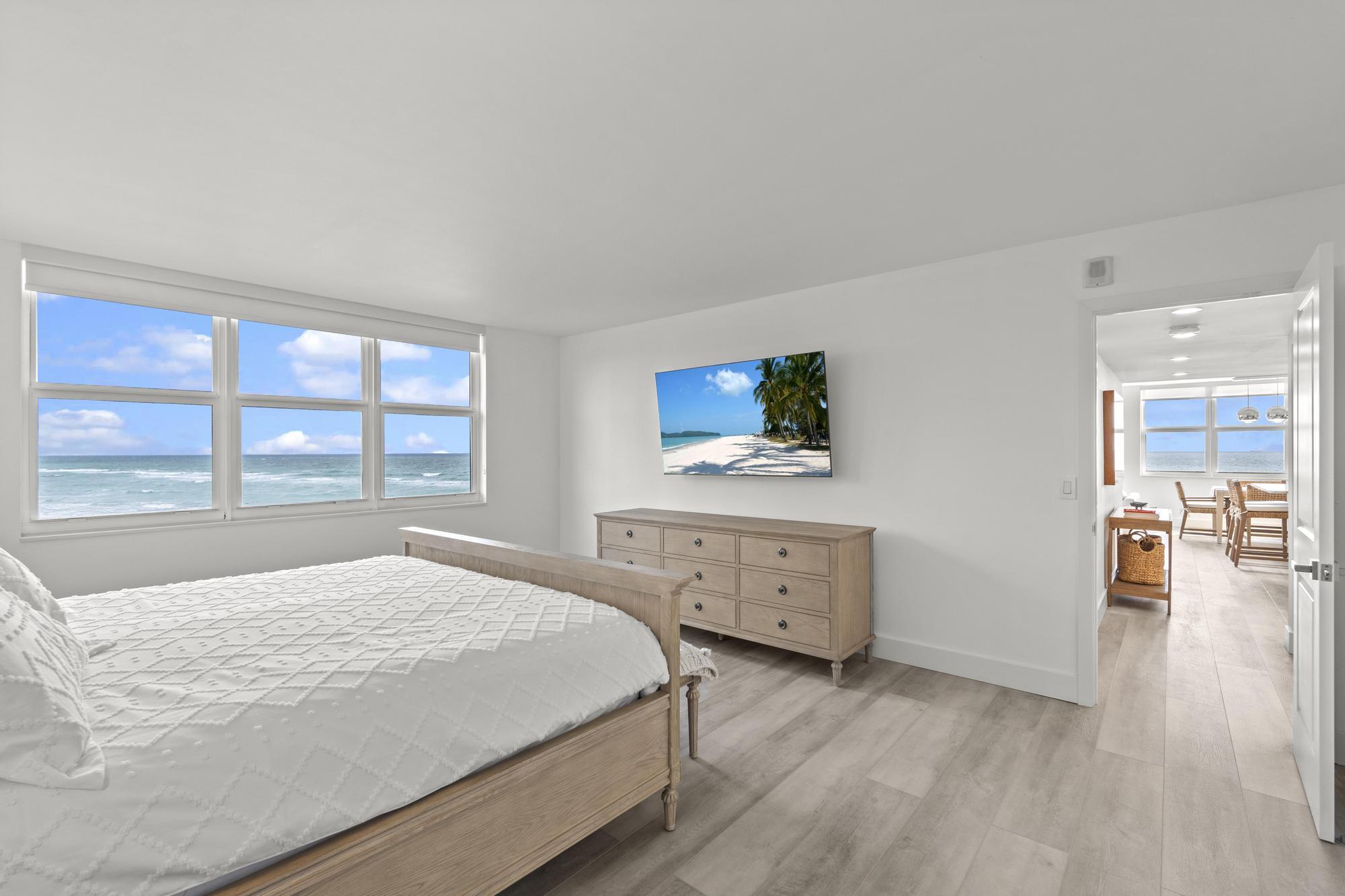 5440 North Ocean Drive, Unit 306 Singer Island, FL 33404 - Photo 25 of 43 a bedroom with a bed and a flat screen tv