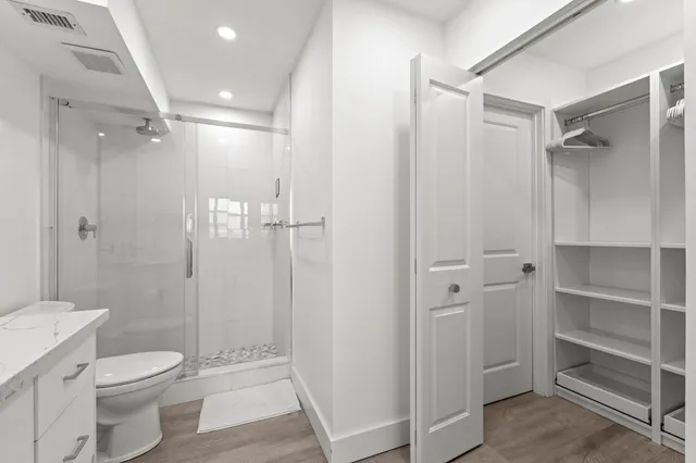 a bathroom with a shower toilet and sink