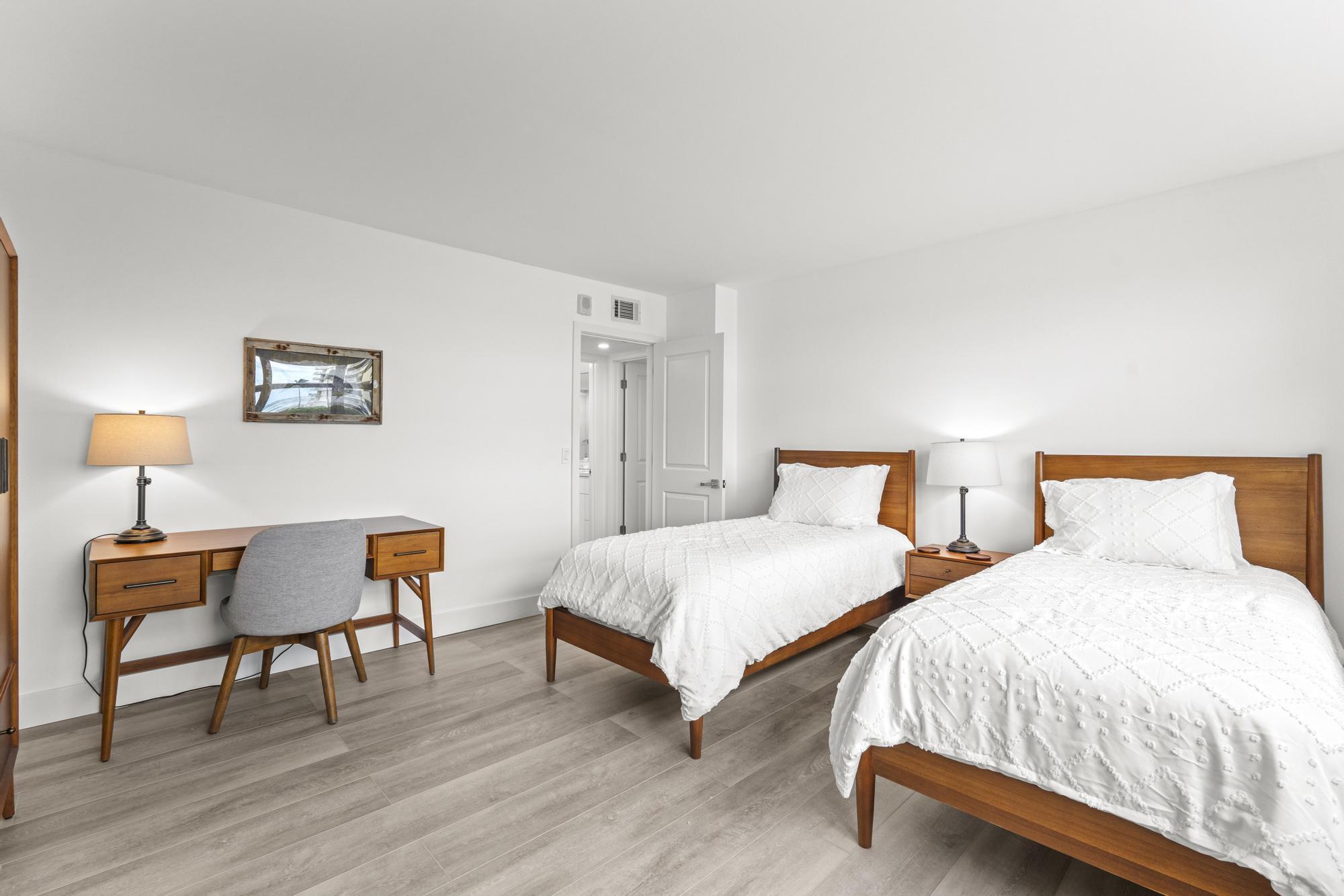 5440 North Ocean Drive, Unit 306 Singer Island, FL 33404 - Photo 31 of 43 a bedroom with two beds and a lamp