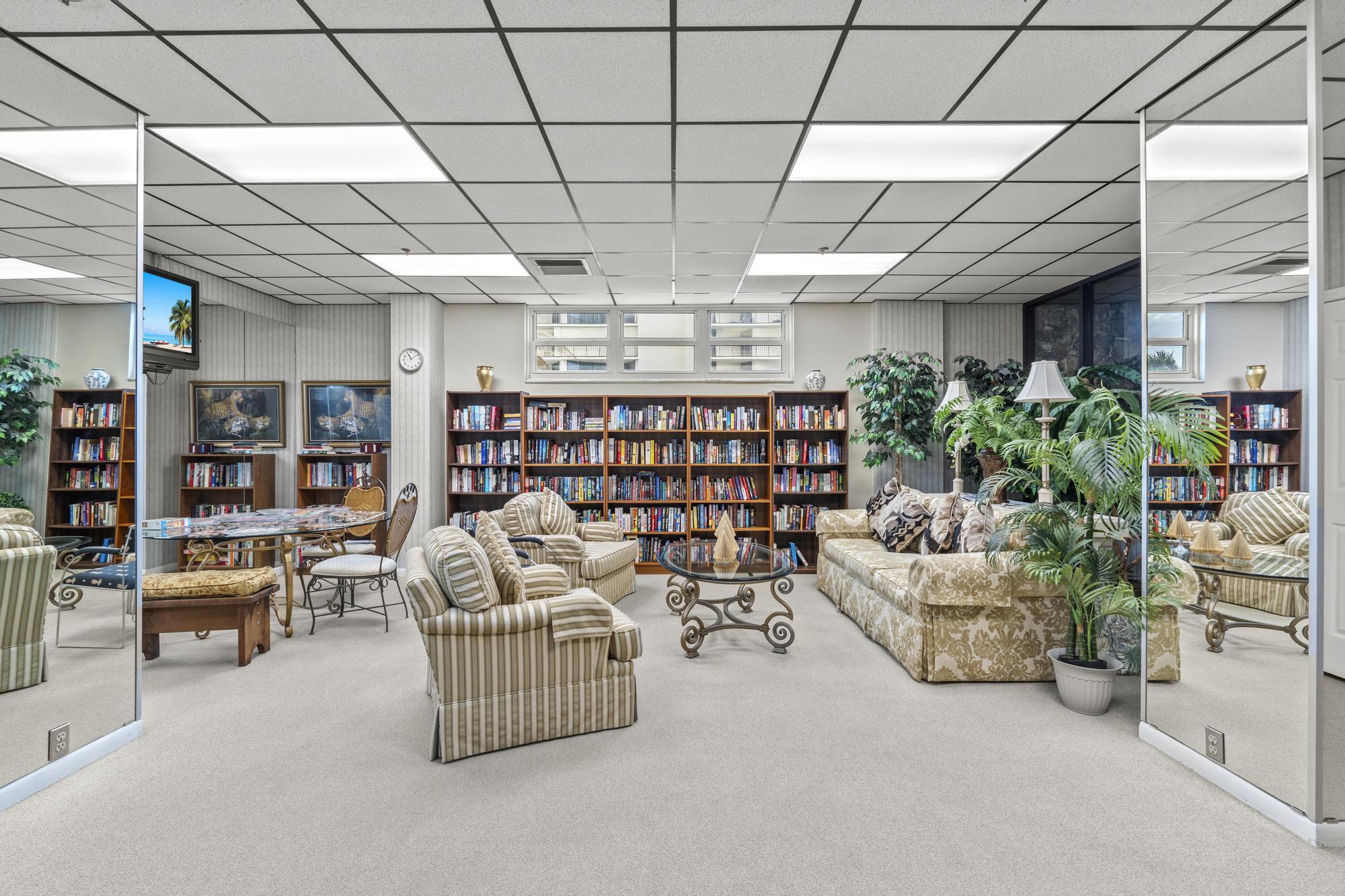 5440 North Ocean Drive, Unit 306 Singer Island, FL 33404 - Photo 37 of 43 a living room with furniture and a book shelf