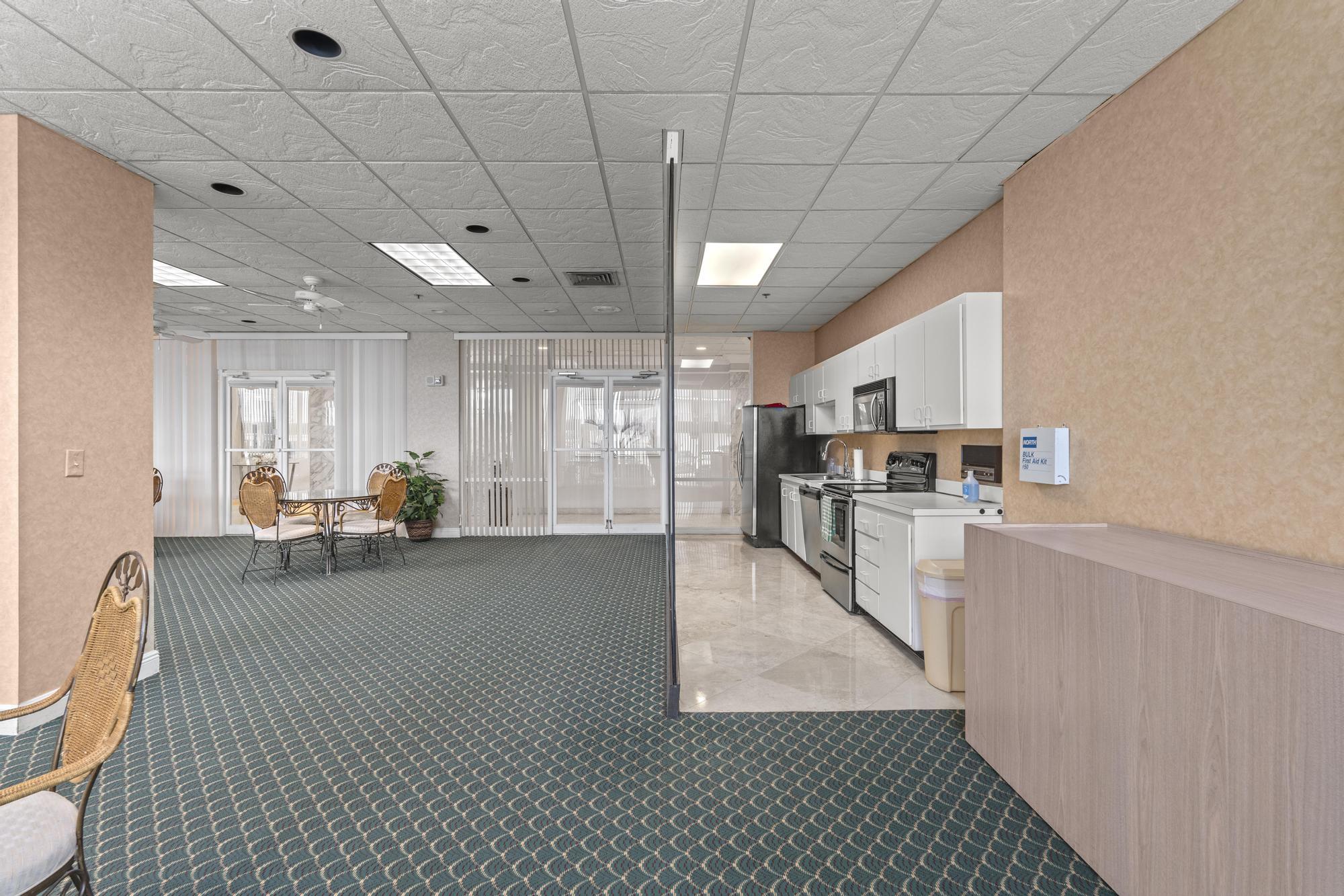 5440 North Ocean Drive, Unit 306 Singer Island, FL 33404 - Photo 39 of 43 a view of a kitchen with kitchen island granite countertop lots of counter top space and stainless steel appliances
