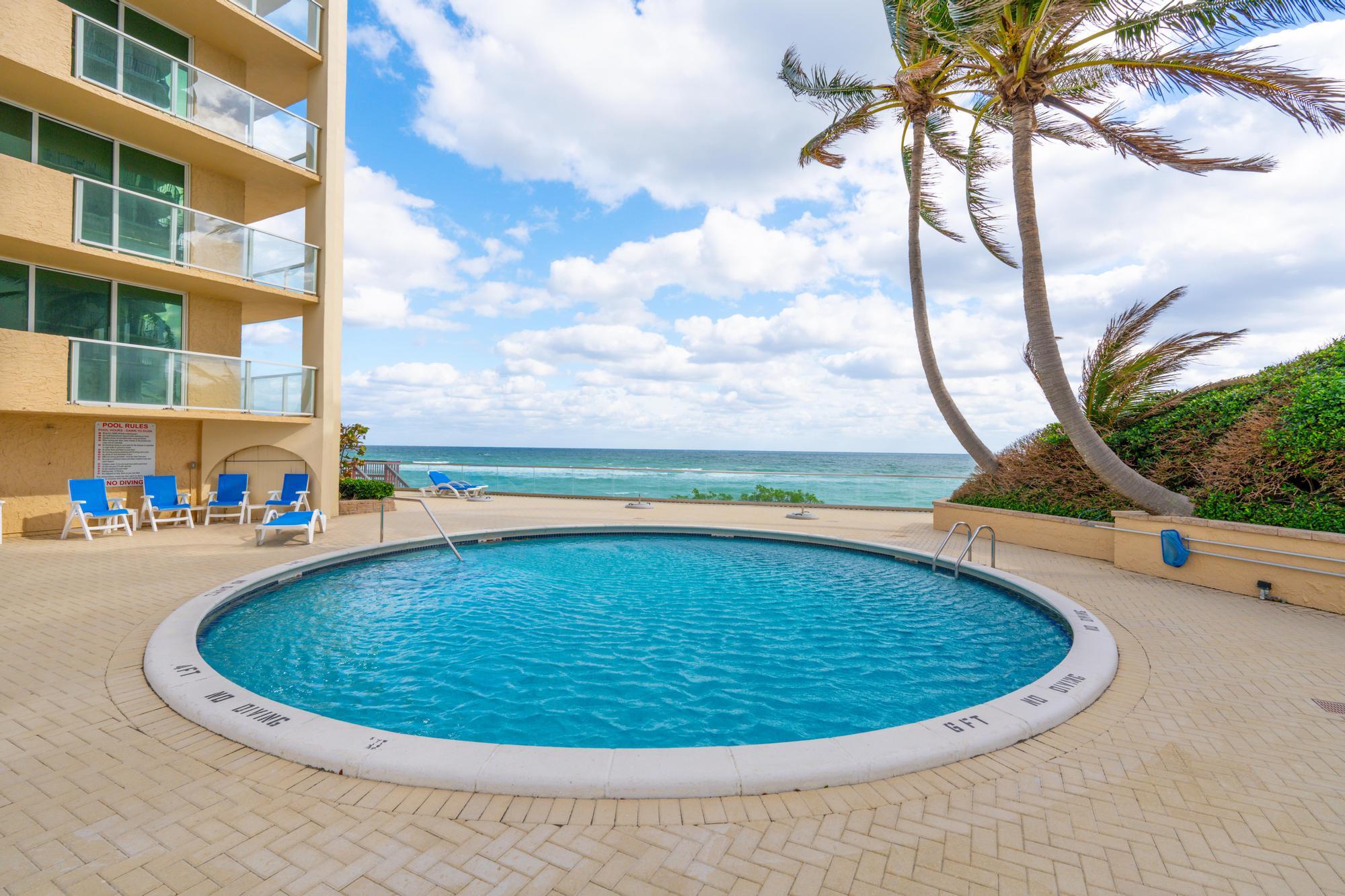 5440 North Ocean Drive, Unit 306 Singer Island, FL 33404 - Photo 41 of 43 a view of a swimming pool with a yard