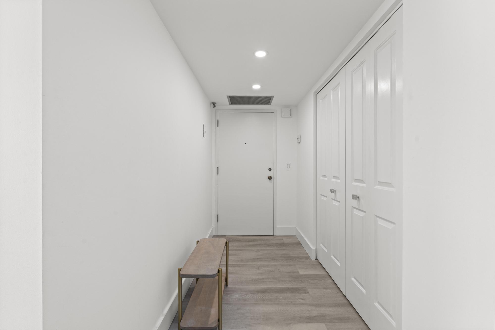 5440 North Ocean Drive, Unit 306 Singer Island, FL 33404 - Photo 5 of 43 a view of a hallway with wooden floor