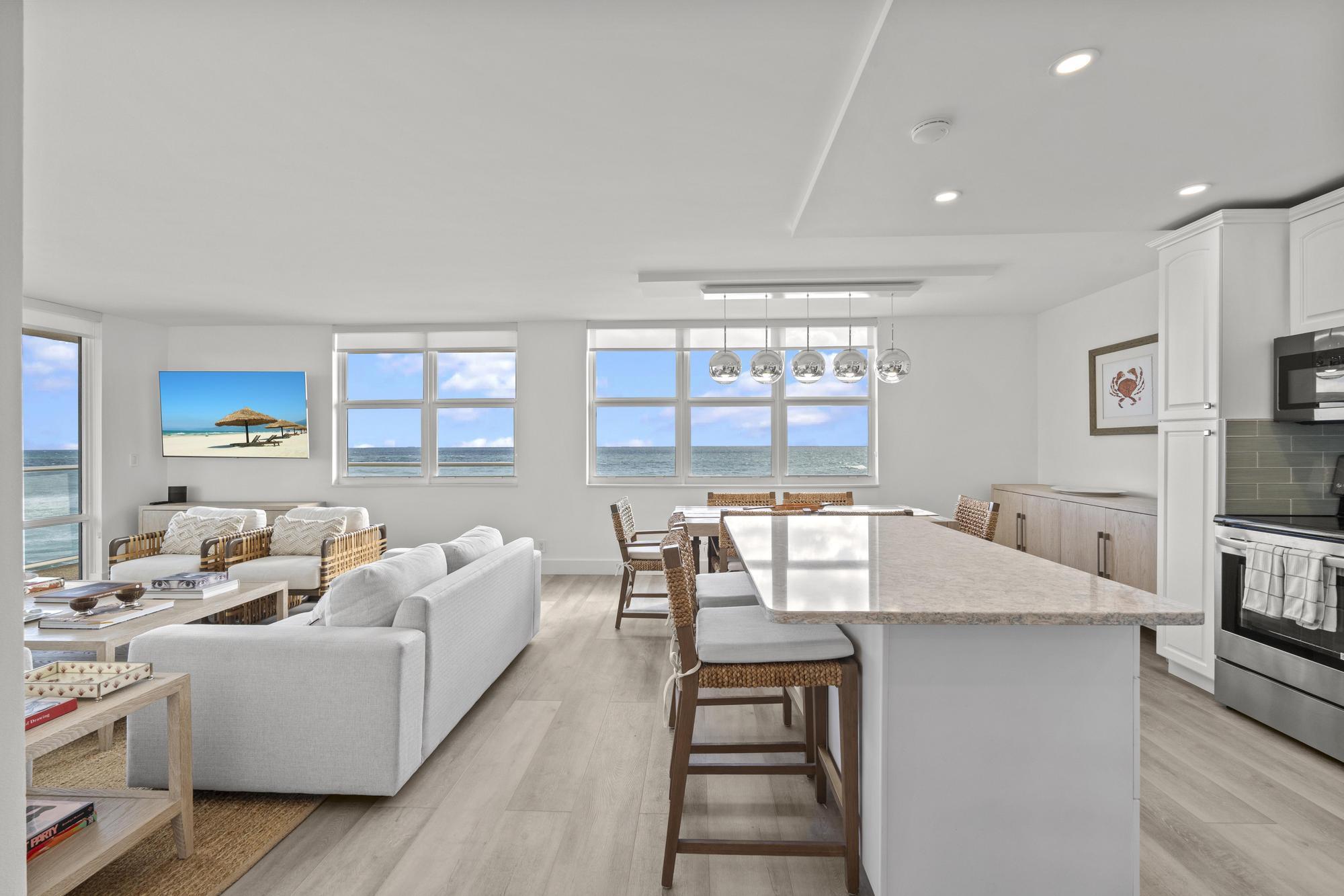 5440 North Ocean Drive, Unit 306 Singer Island, FL 33404 - Photo 7 of 43 a living room with furniture and a table