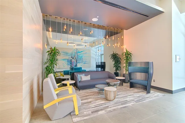 a living room with furniture and a potted plant