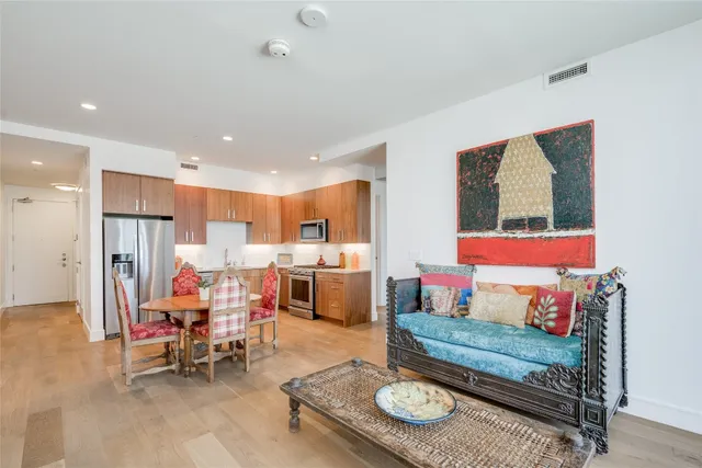 a living room with furniture and kitchen view