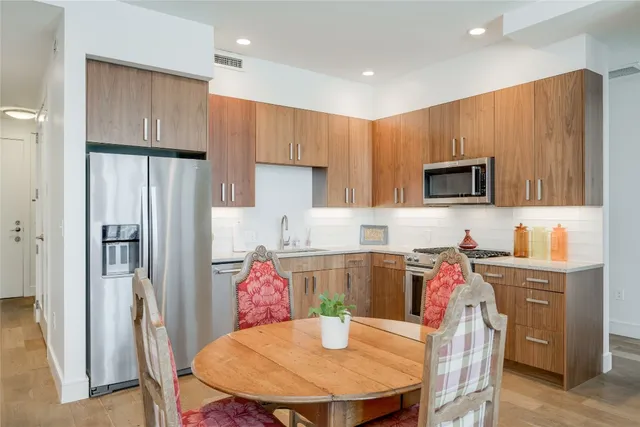 a kitchen with stainless steel appliances a refrigerator stove microwave and cabinets