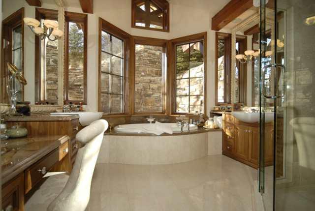 418 Wrights Road Aspen, CO 81612 - Photo 9 of 9 a bathroom with a tub a sink and a large mirror next to a large window