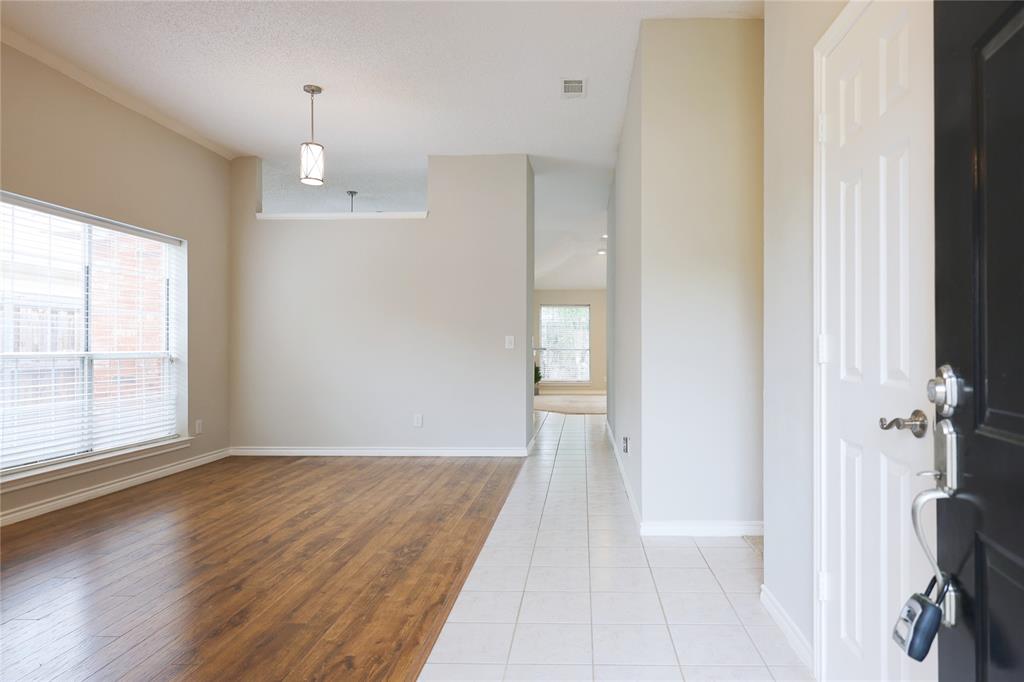 8112 Dock Street Frisco, TX 75035 - Photo 5 of 34 an empty room with wooden floor and windows