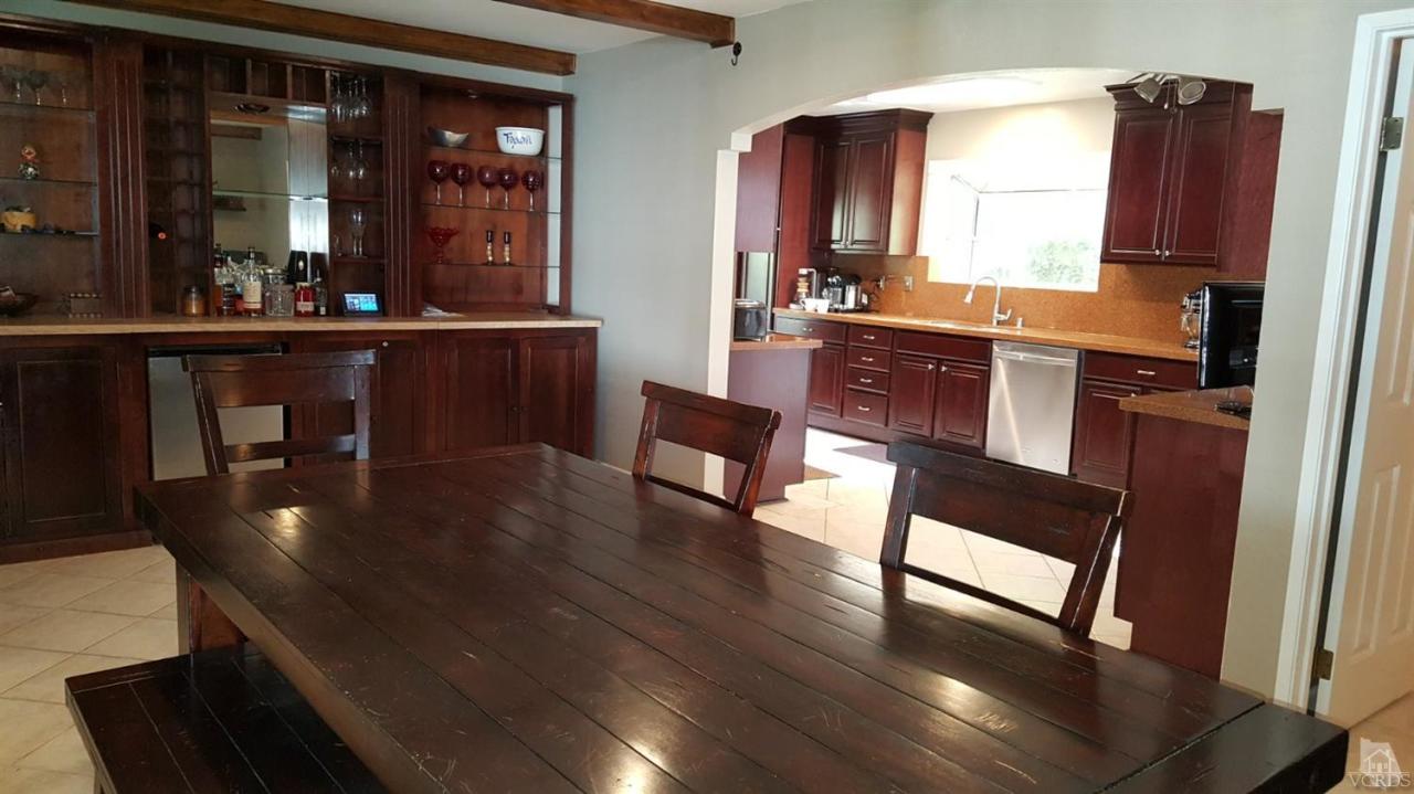 6392 White Street Simi Valley, CA 93063 - Photo 12 of 30 a kitchen with stainless steel appliances granite countertop a refrigerator a stove and a dining table view