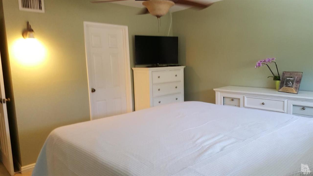 6392 White Street Simi Valley, CA 93063 - Photo 13 of 30 a bedroom with a bed and a flat tv screen on dresser