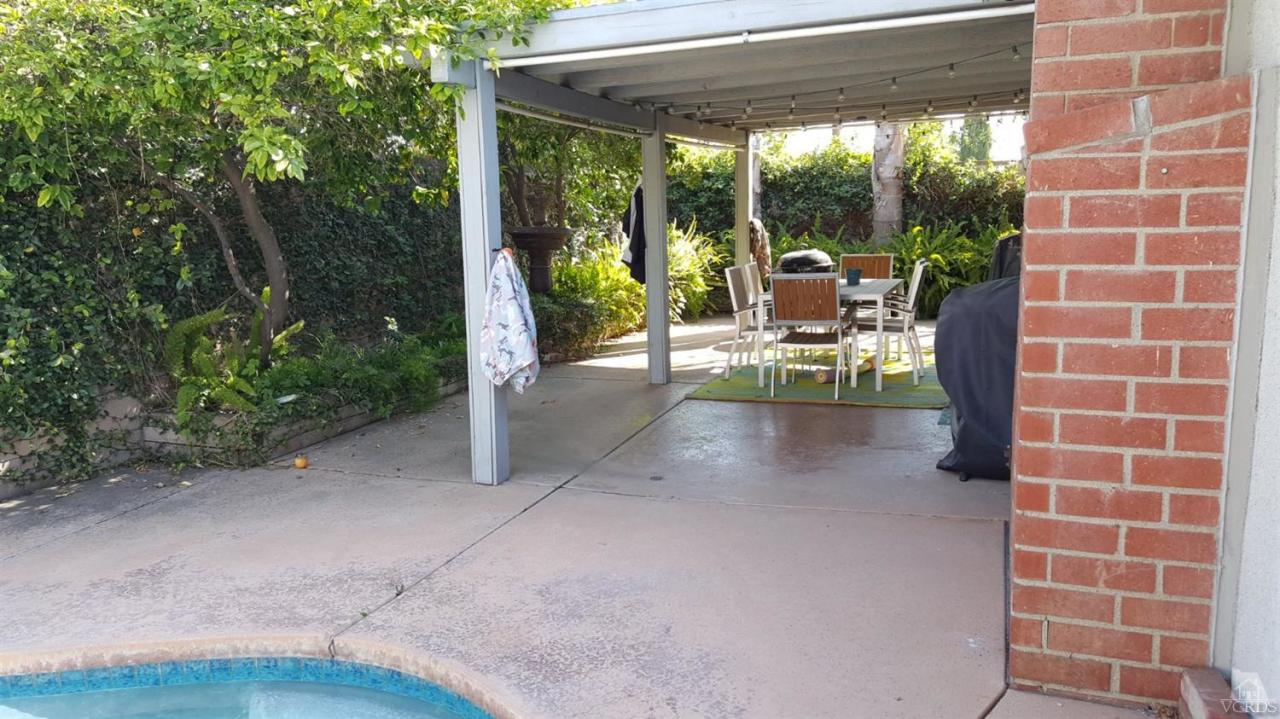 6392 White Street Simi Valley, CA 93063 - Photo 25 of 30 a view of a patio with a table chairs and a backyard