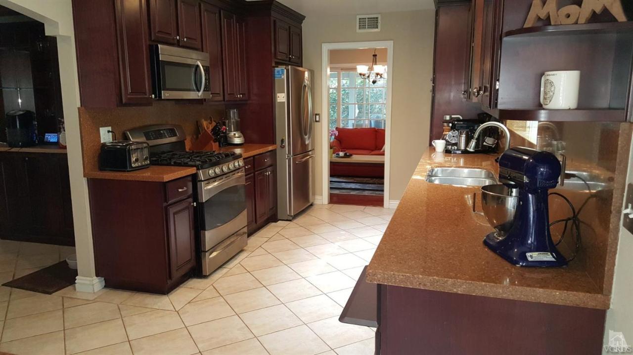 6392 White Street Simi Valley, CA 93063 - Photo 8 of 30 a kitchen with stainless steel appliances granite countertop a sink and a stove