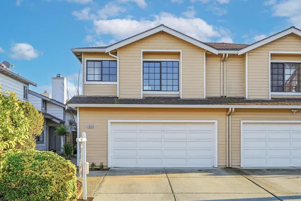 a view of a brick house with many windows