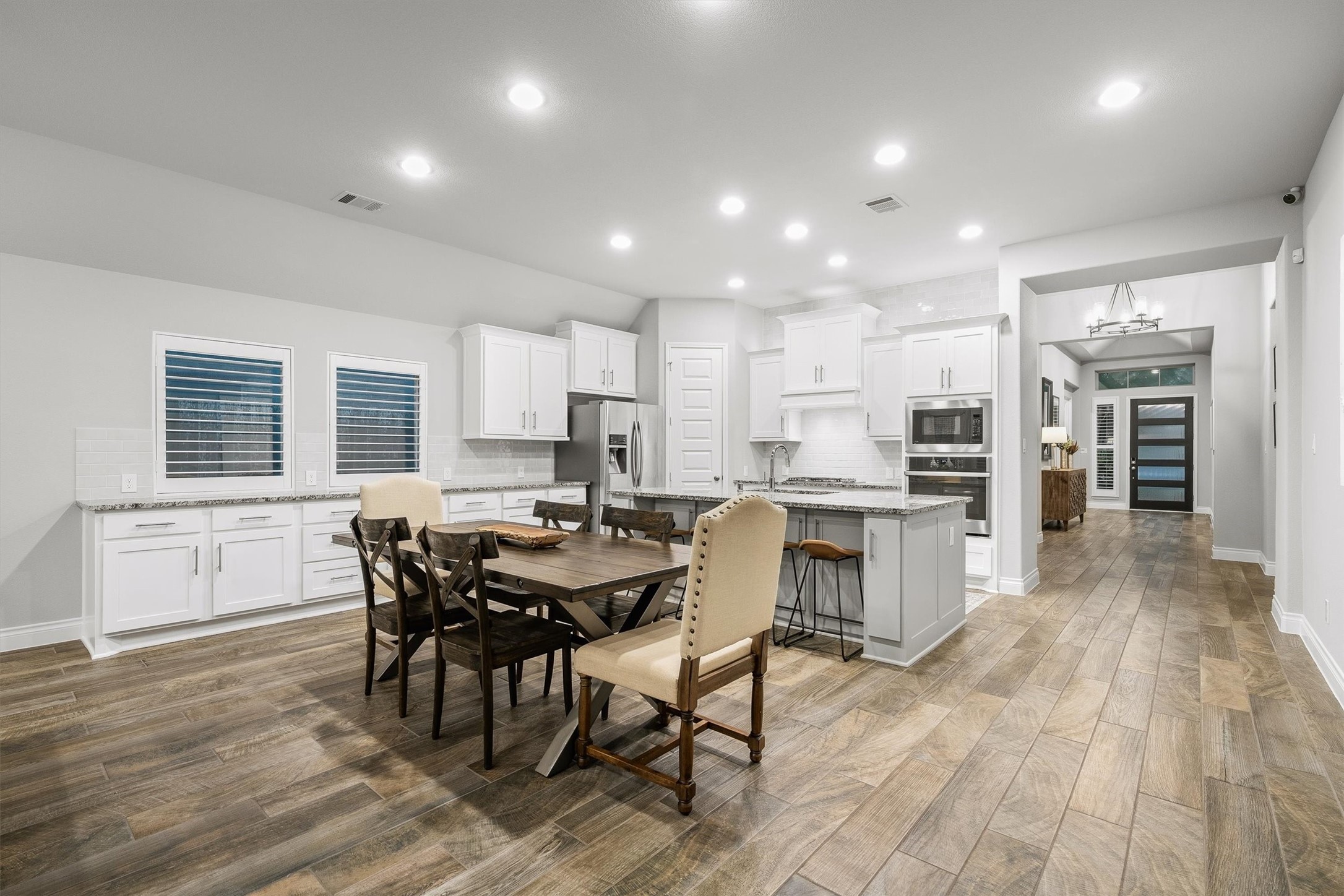 29118 Lantana Ridge Court Fulshear, TX 77441 - Photo 7 of 29 The dining area sits right next to the kitchen, boasting by multiple windows that fill the space with natural light and extra cabinet and counter space, creating a warm, inviting atmosphere for every meal.