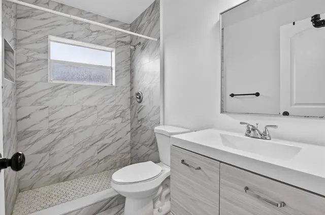 a bathroom with a sink toilet and shower