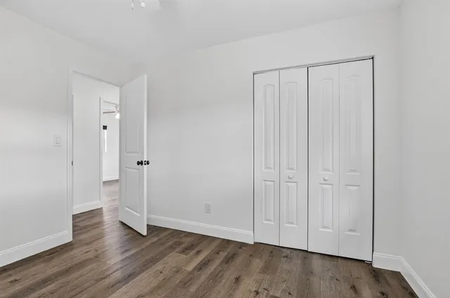 an empty room with wooden floor