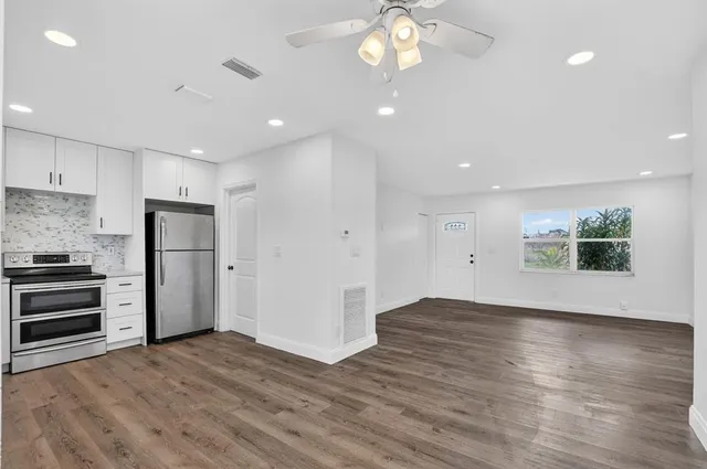 an empty space with kitchen view and stainless steel appliances
