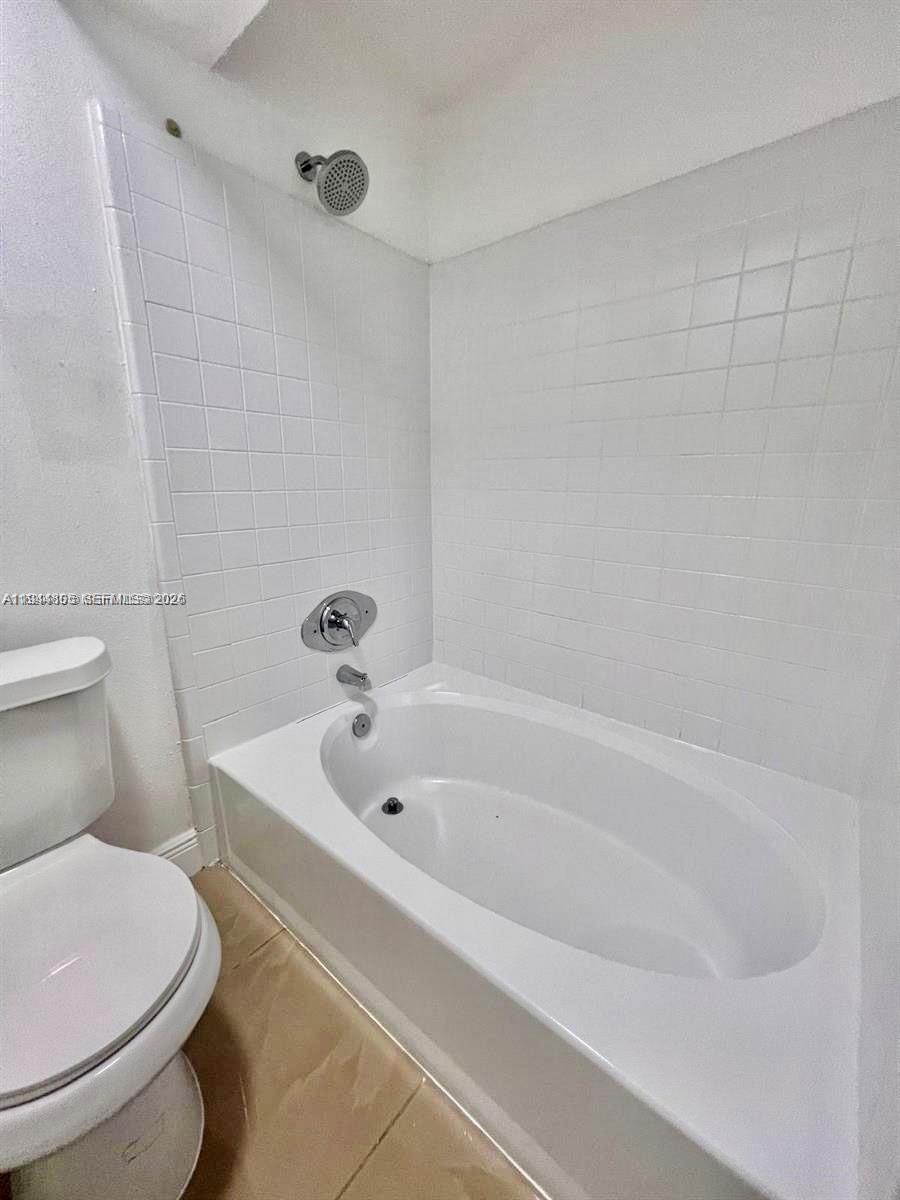 10440 Southwest 156th Court, Unit 722 Miami, FL 33196 - Photo 8 of 23 a white bath tub sitting next to a toilet