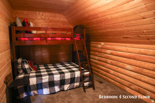 15253 Mill Road, Unit 62 Huntsville, UT 84317 - Photo 20 of 48 Attic bedroom featuring natural wood plank walls, a vaulted wood plank ceiling, and carpeted flooring