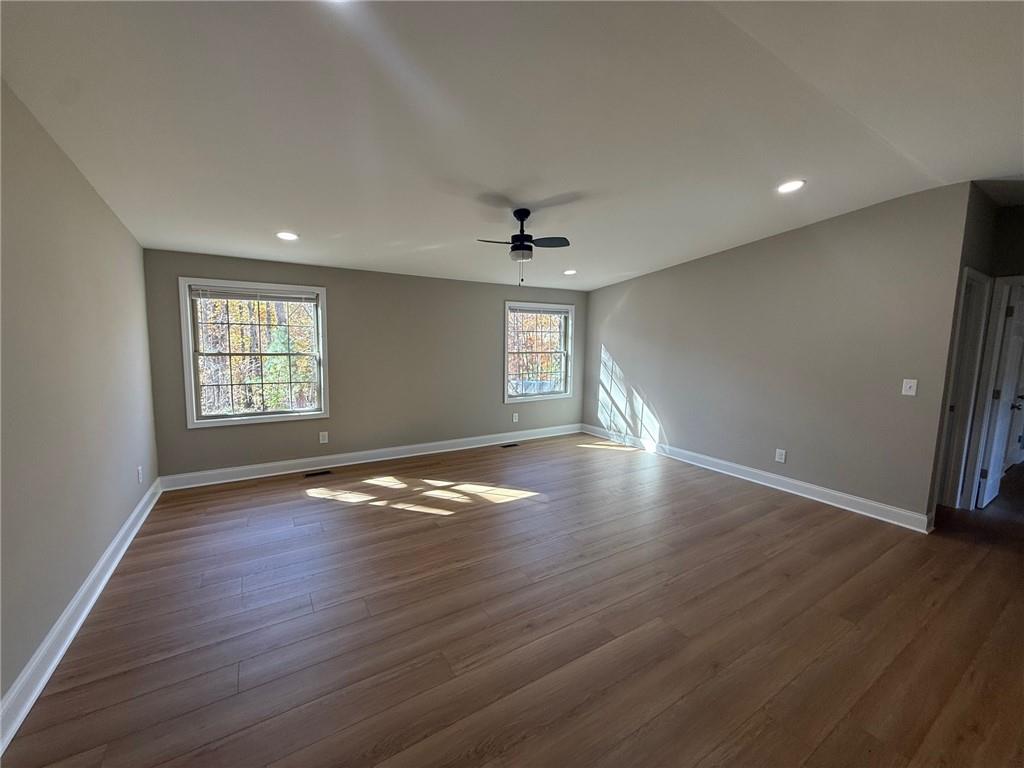 3726 Bolding Road Flowery Branch, GA 30542 - Photo 2 of 8 an empty room with wooden floor and windows