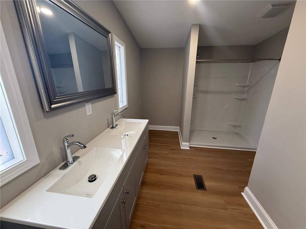 3726 Bolding Road Flowery Branch, GA 30542 - Photo 6 of 8 a bathroom with a tub sink and mirror
