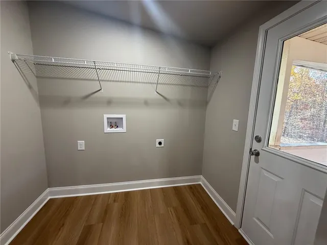 a view of a room with wooden floor and windows