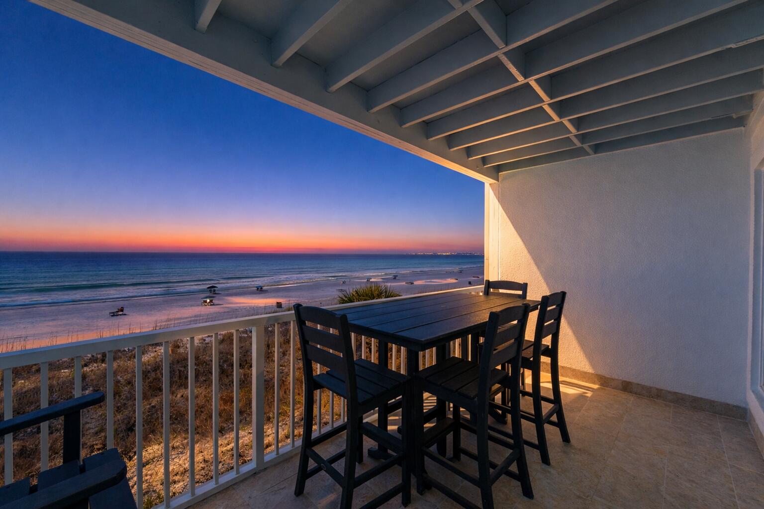 23011 Front Beach Road, Unit E8 Panama City Beach, FL 32413 - Photo 54 of 60 a view of a chairs and table on the terrace