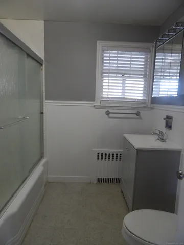 a bathroom with a window a sink and a toilet