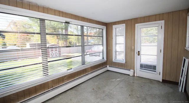 a view of an entryway with wooden floor