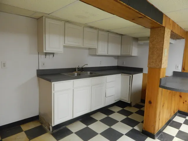 a living room with a black white checkered floor with a black white checkered floor