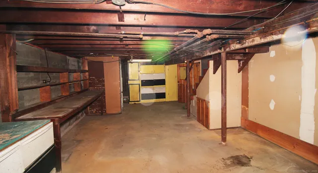 a view of a brick house with a big yard and large trees