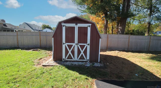 a view of a house with a large window and a yard with stairs