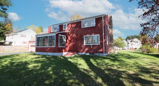 a view of a lake with a building and trees in the background