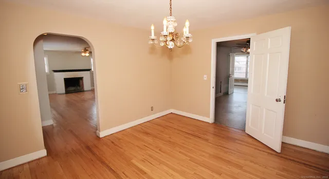 wooden floor in an empty room with a mirror