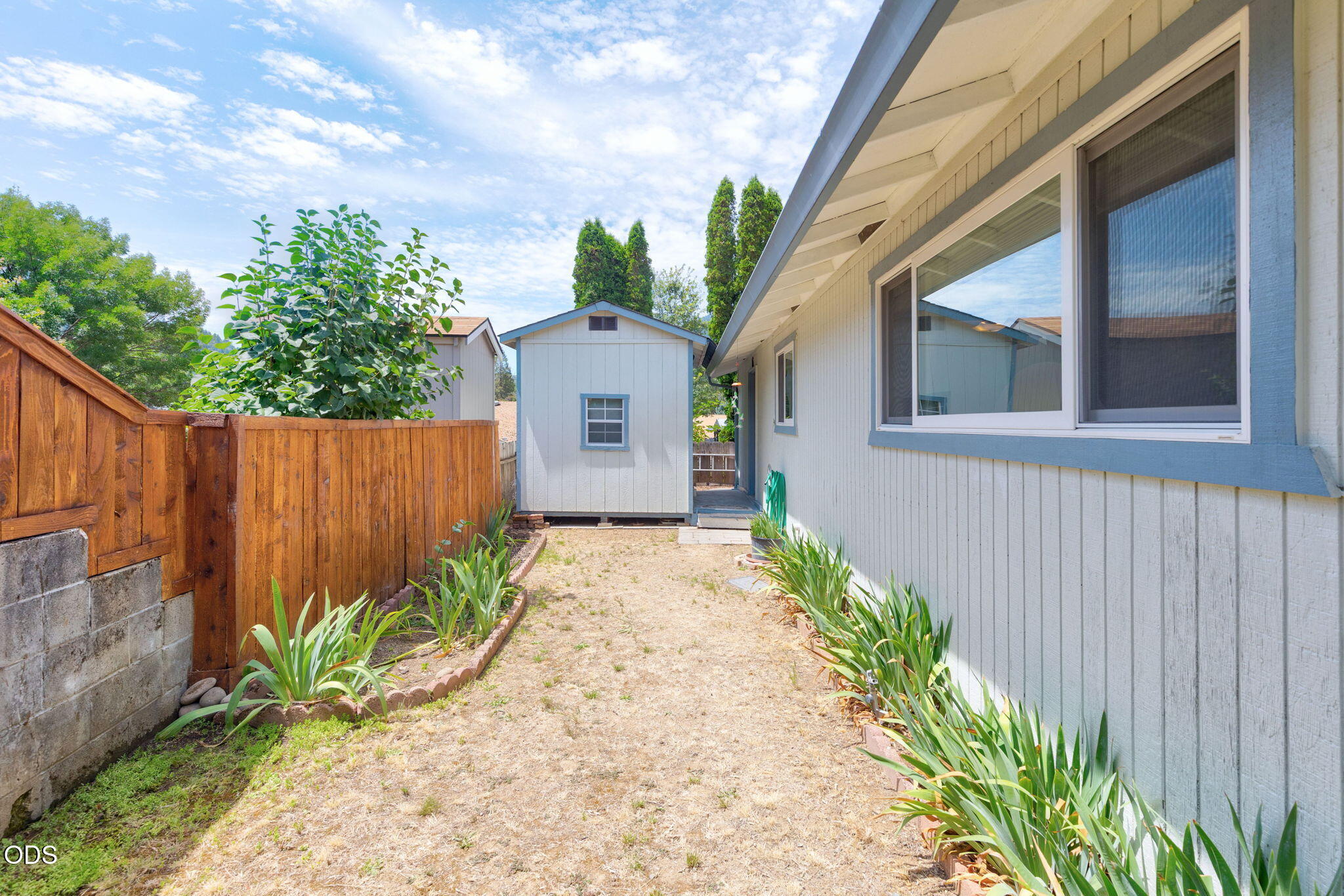 103 Brookside Court Rogue River, OR 97537 - Photo 16 of 27 a view of a house with a small yard and wooden fence