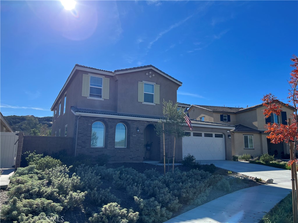 45766 Altree Court Temecula, CA 92592 - Photo 2 of 13 a red brick house with a small yard