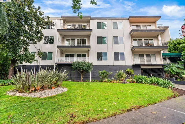 a front view of a residential apartment building with a yard