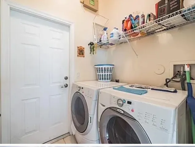 a dining hall with stainless steel appliances granite countertop a dining table and chairs with wooden floor