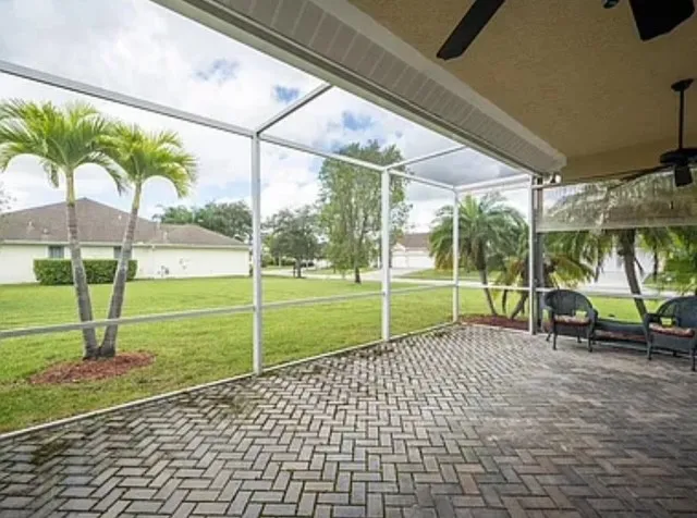 a view of a green field with wooden fence