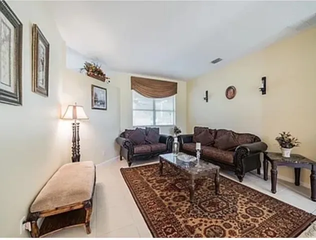 a living room with furniture and a rug