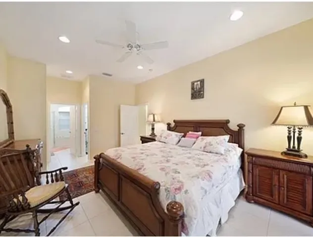 a spacious bedroom with a bed a couch and dresser