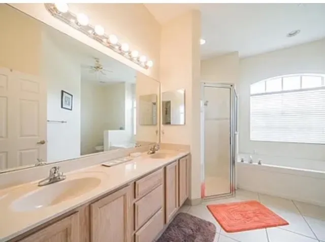 a spacious bathroom with a sink a mirror and a bathtub