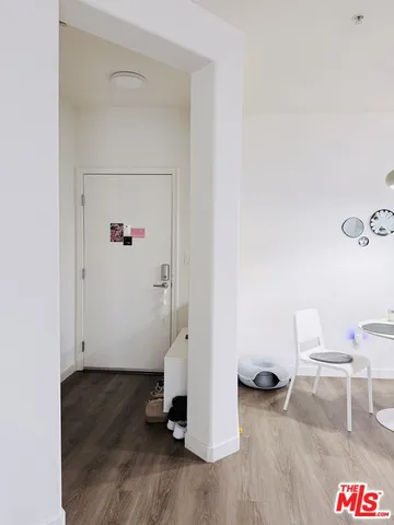 a view of a room with wooden floor and lounge chair